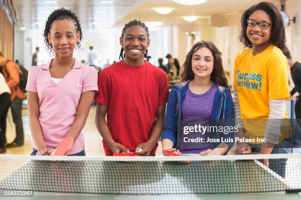 volunteer and children playing table tennis in community center - table tennis bat stock pictures, royalty-free photos & images