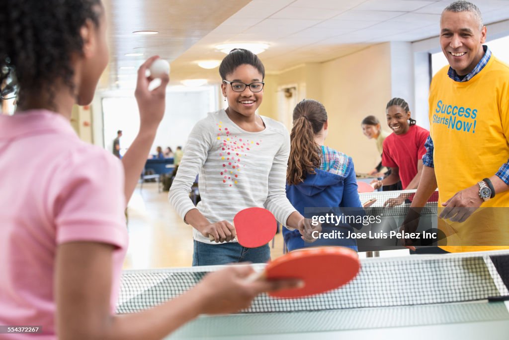 Children playing table tennis in community center