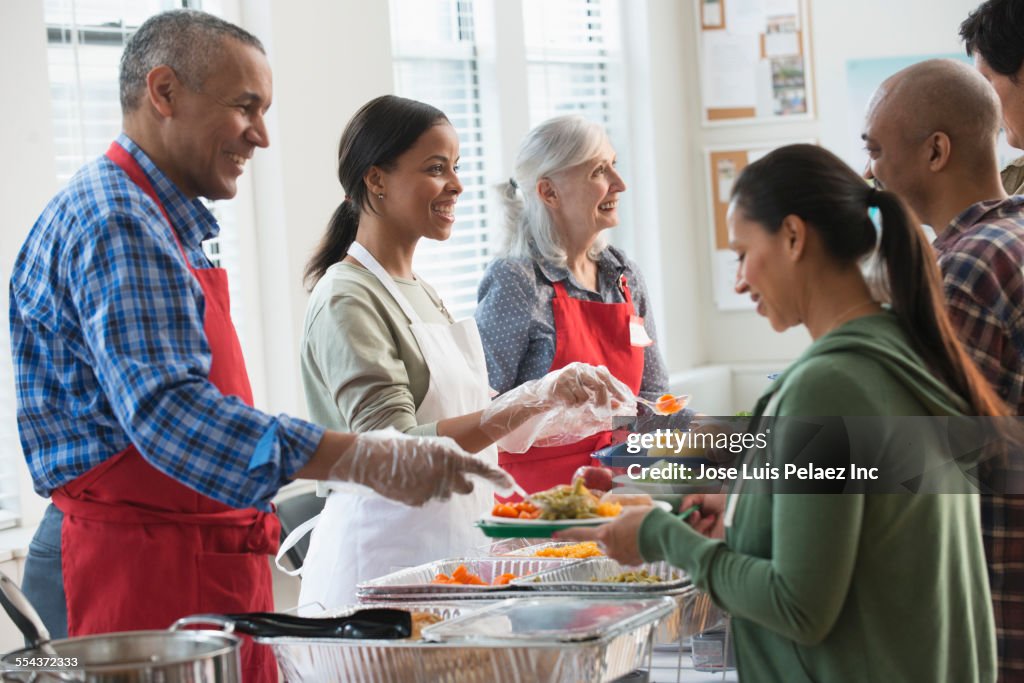 Volunteers serving food at community kitchen