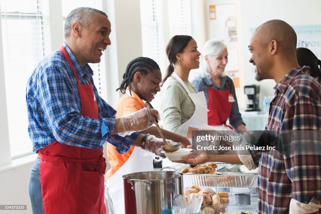 Volunteers serving food at community kitchen