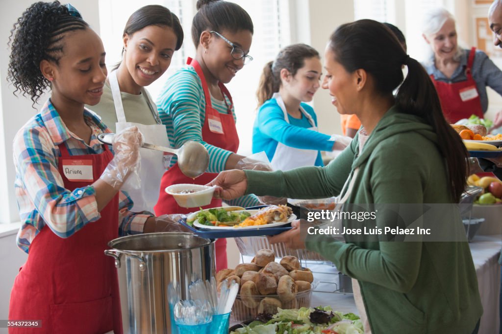 Volunteers serving food at community kitchen