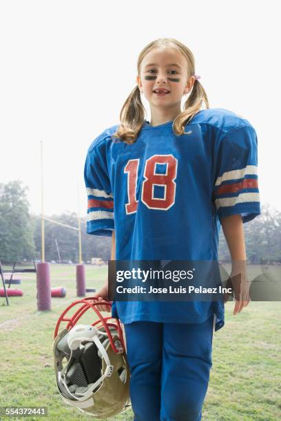caucasian girl wearing football jersey and helmet - west new york new jersey stock-fotos und bilder