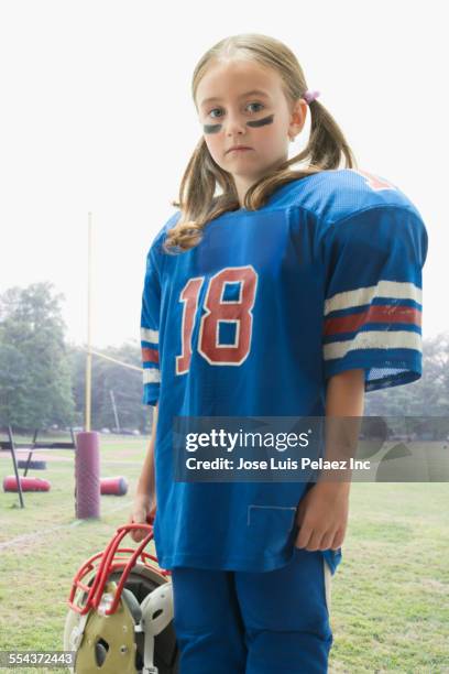 caucasian girl wearing football jersey and helmet - girl american football player stock pictures, royalty-free photos & images