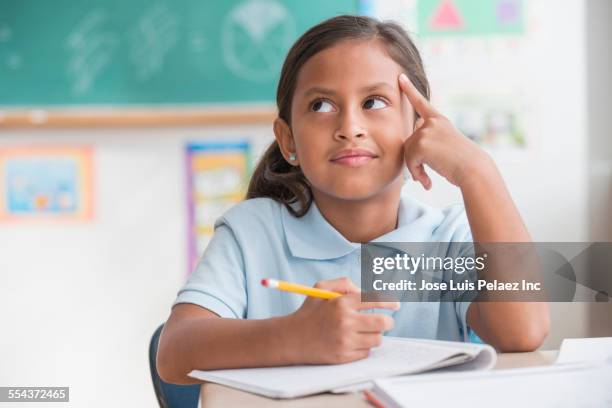 hispanic student thinking in classroom - kid thinking stock pictures, royalty-free photos & images