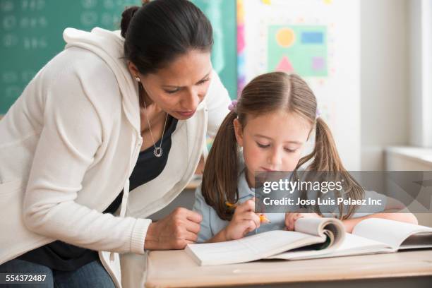 Helping Others In Class Child Helping Classroom Photos and Premium High Res Pictures - Getty Images