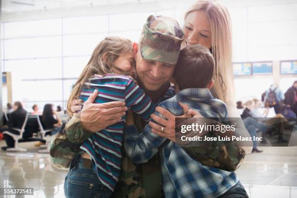 caucasian returning soldier greeting family - military spouse stock-fotos und bilder