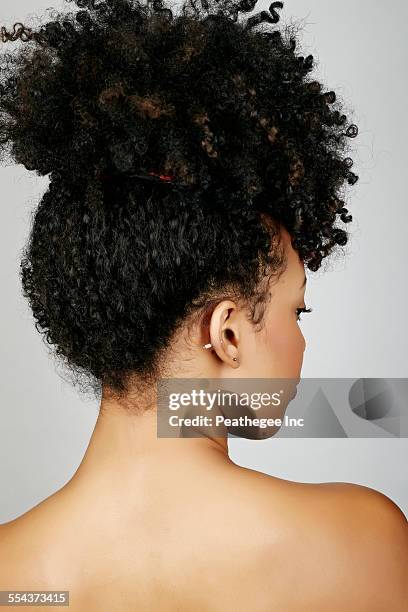 rear view of mixed race woman looking over shoulder - curly hair back stock pictures, royalty-free photos & images