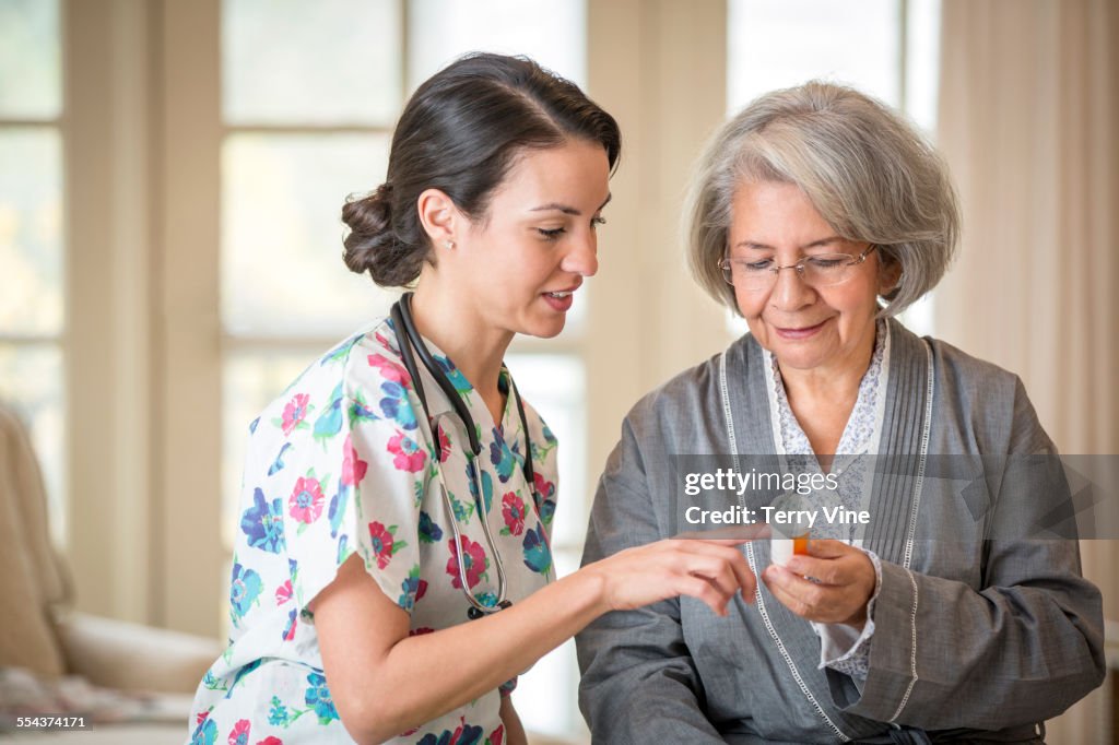 Nurse explaining medication to patient in home
