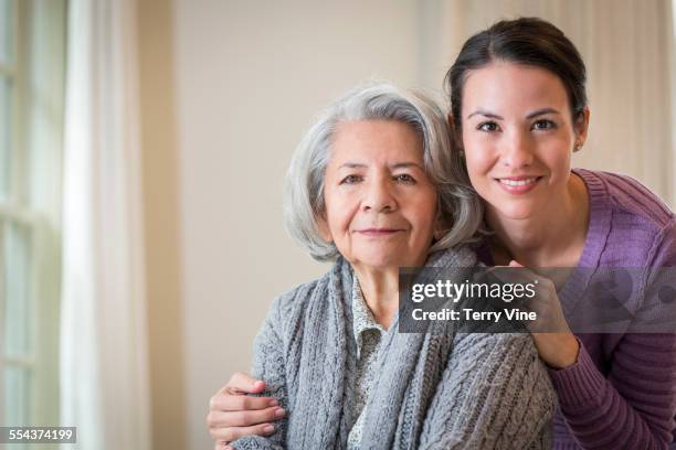 close up of smiling daughter hugging mother - fragility stock pictures, royalty-free photos & images