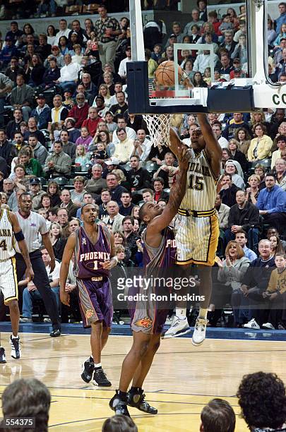 Guard Ron Artest of the Indiana Pacers dunks over forward Alton Ford of the Phoenix Suns during the NBA game at Conseco Fieldhouse in Indianapolis,...