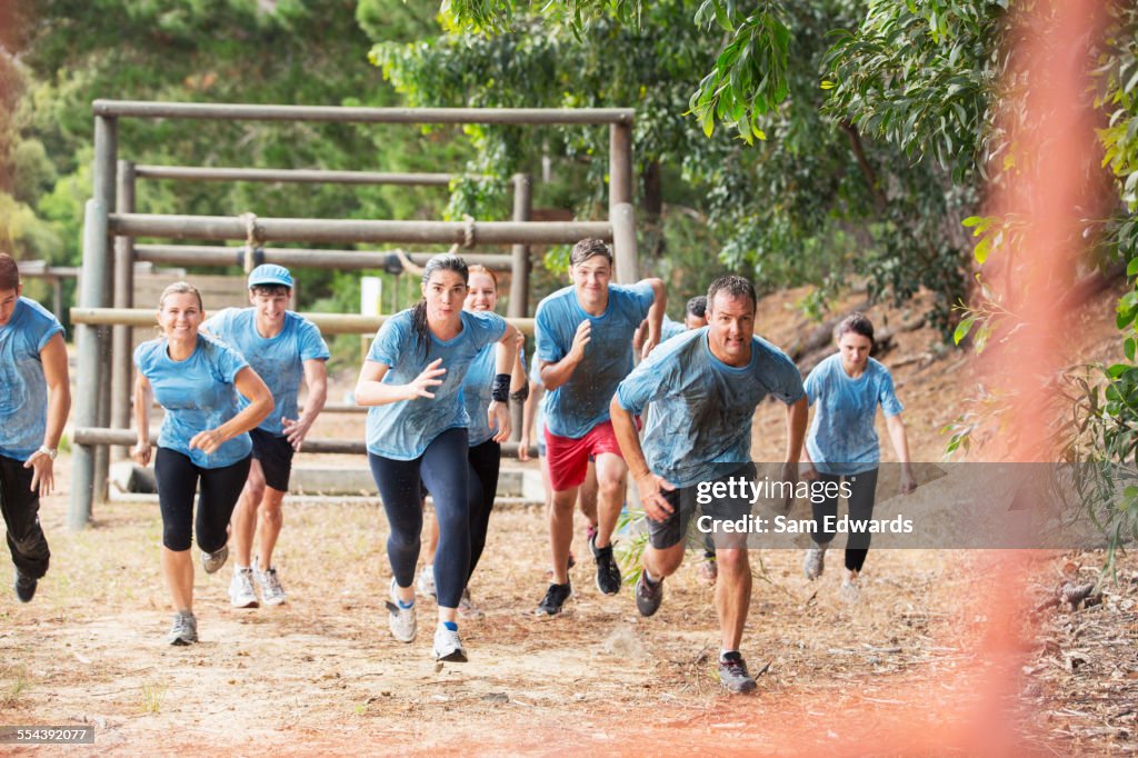 Team running on boot camp obstacle course