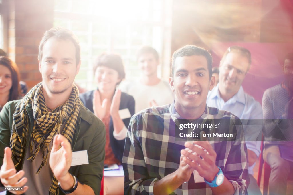 Portrait of smiling audience clapping