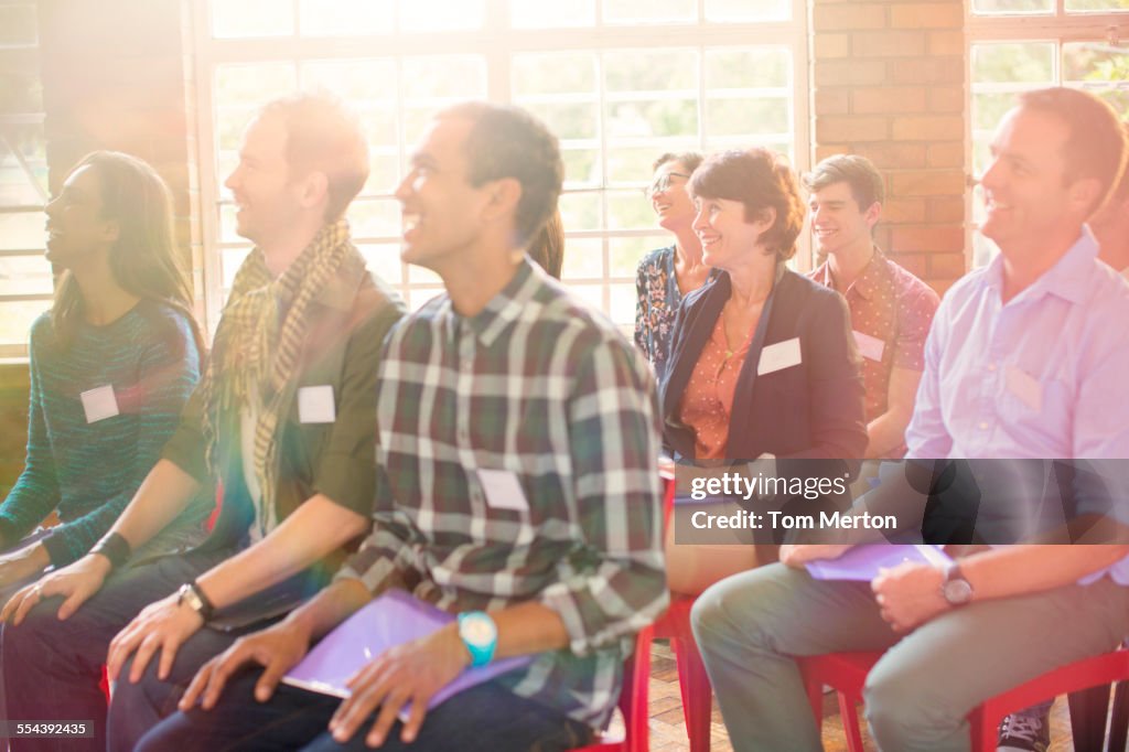 Audience smiling in community center