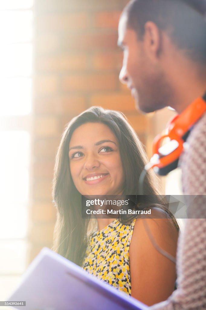 Smiling businessman and businesswoman in meeting