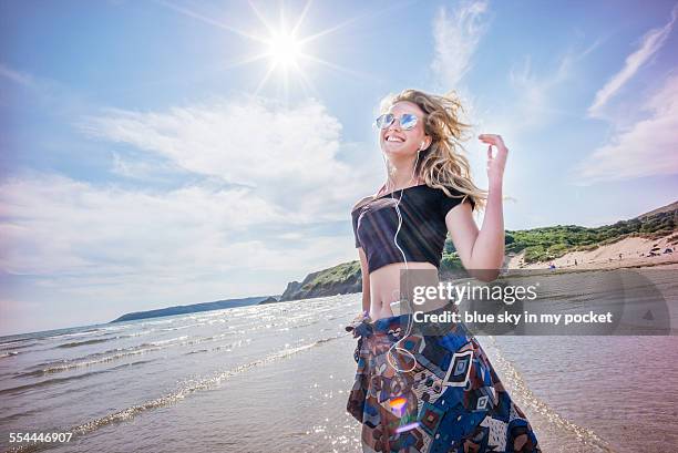 young girl dancing on a beach - sarong stock pictures, royalty-free photos & images