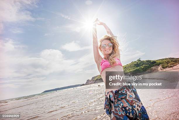 young girl on a beach dancing to music - girls in bras photos stock pictures, royalty-free photos & images