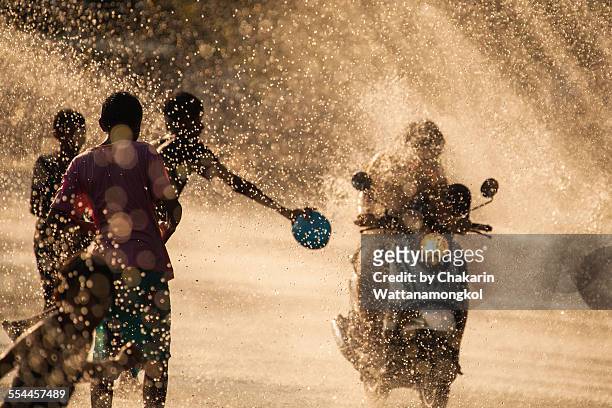 water splashing in songkran festival - songkran festival stock-fotos und bilder