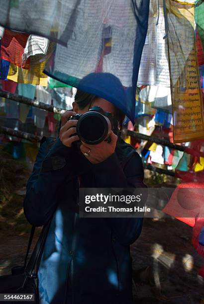 taking pictures through prayer flags in bhutan - bumthang ストックフォトと画像