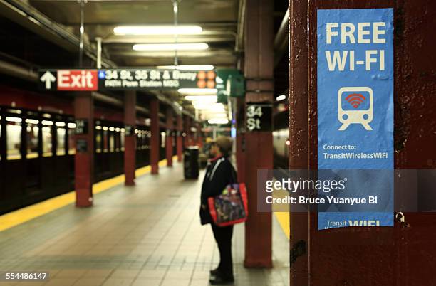 sign marking free wi-fi spot at subway station - free sign stock-fotos und bilder