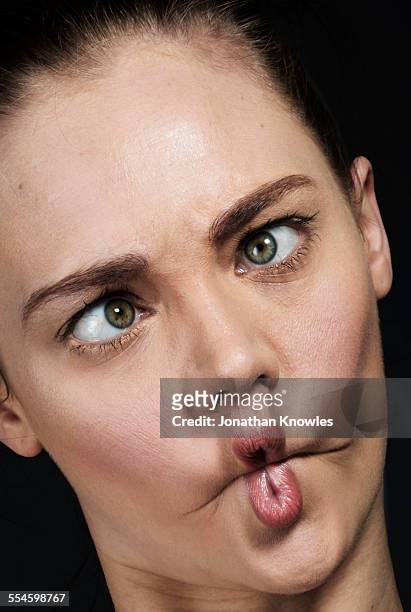 woman pulling silly faces - cross eyed stock pictures, royalty-free photos & images