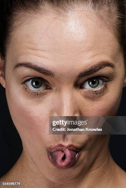 woman rolling her tongue - stick tongue out foto e immagini stock