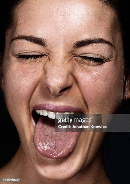 female sticking tongue out with eyes closed - sticking out tongue stock pictures, royalty-free photos & images
