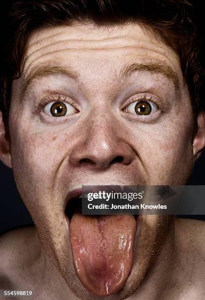 male sticking tongue out - 舌を出す ストックフォトと画像