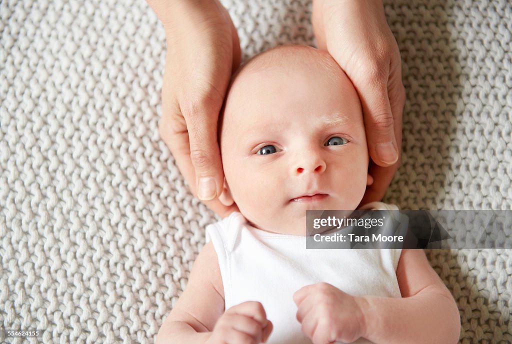 Baby's head being held