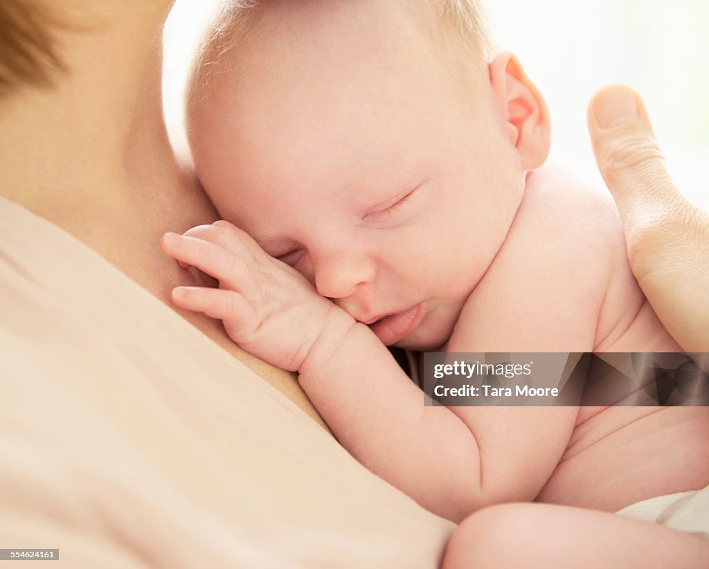 Newborn baby being held by mother