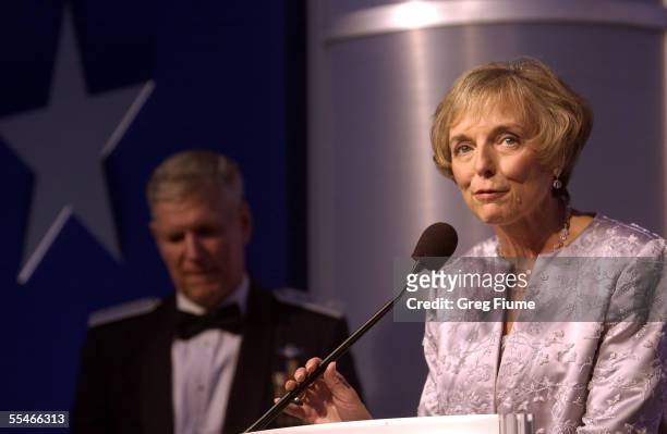 Mary Jo Myers speaks to the crowd as her husband General Richard B. Myers looks on at the USO Gala on September 14, 2005 at the Hilton Washington in...
