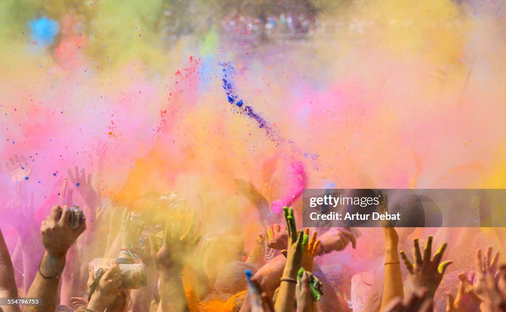 People throwing colorful powder in Holi