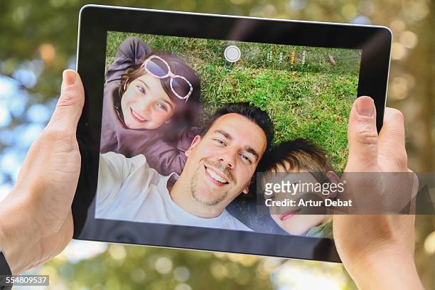 doing a selfie with my family on tablet - photographing garden stock pictures, royalty-free photos & images