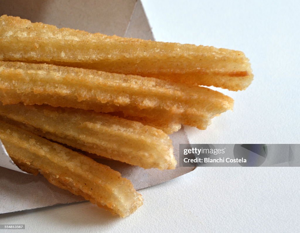 Churros with sugar on white background