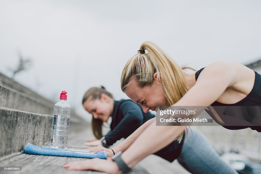 Girlfriends doing push-ups together
