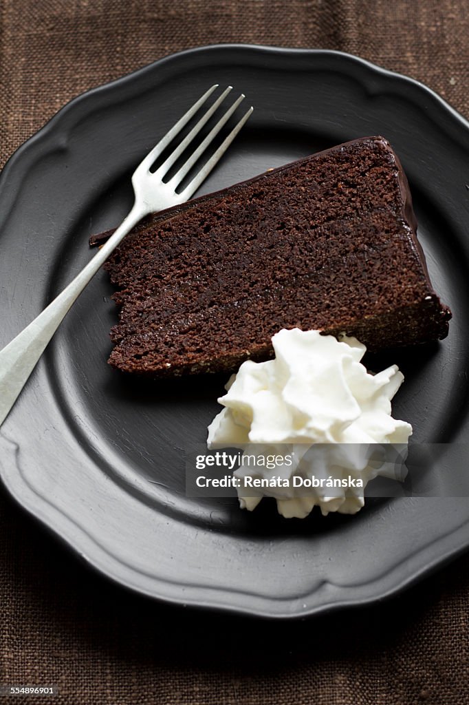 Piece of Sacher torte with cream