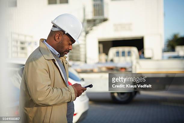 Architect using phone at construction site