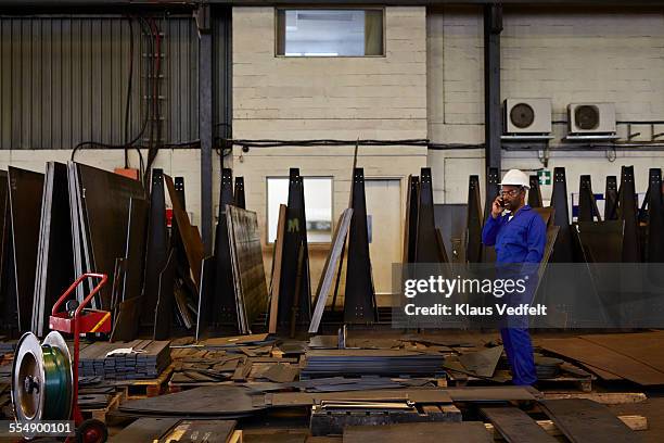 steel worker on the phone inside factory - steel worker stock pictures, royalty-free photos & images