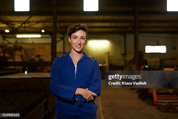portrait of female steel worker - overall stockfoto's en -beelden