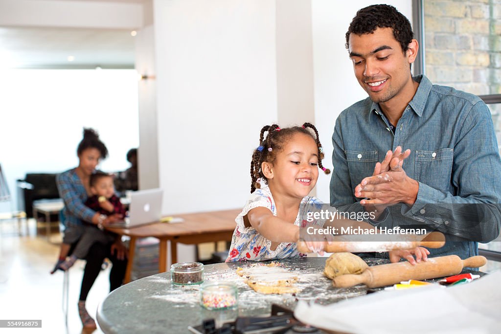 Mixed race family at home together