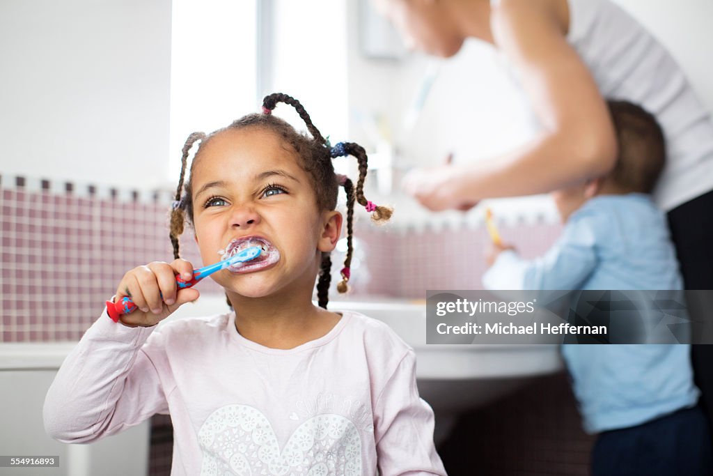 Young girl brushes teeth