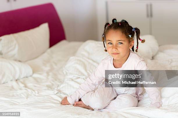 young girl sitting on bed - braiding hair stock pictures, royalty-free photos & images