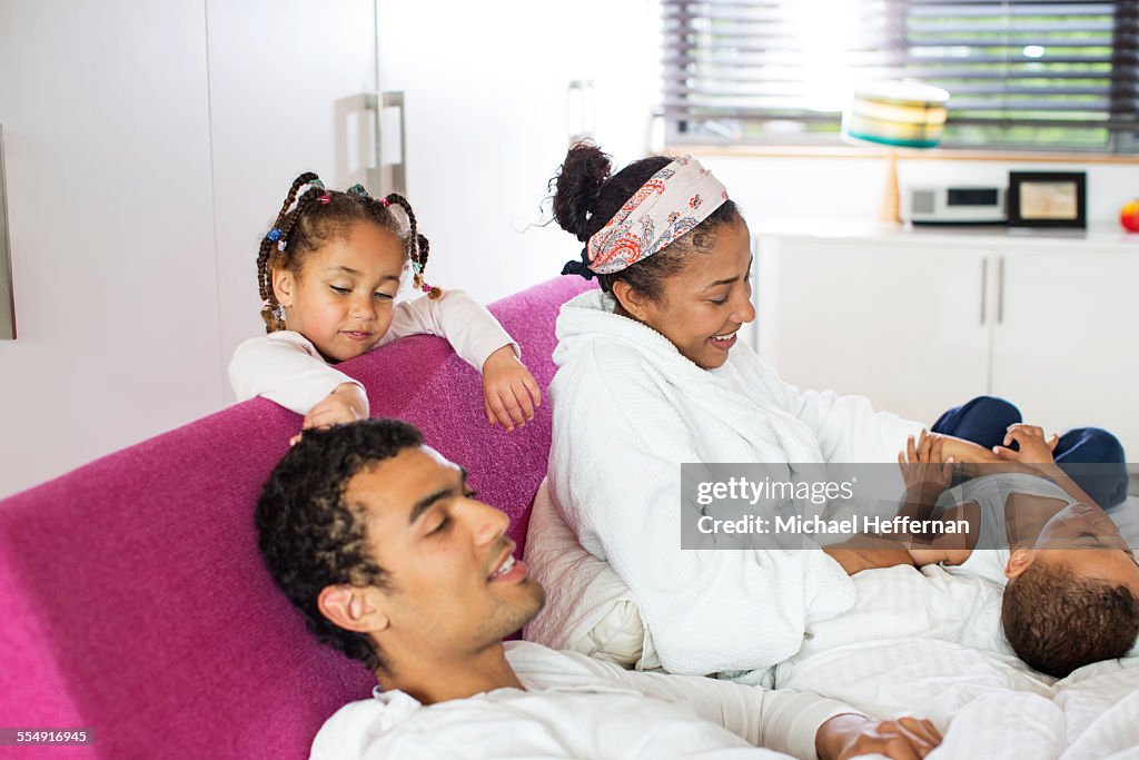 Family having fun in bed