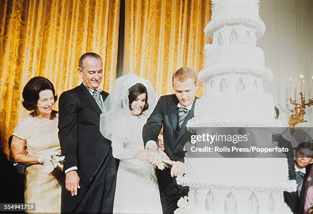 President of the United States, Lyndon B Johnson and Lady Bird Johnson look on as their daughter Luci Baines Johnson and husband Patrick Nugent cut...