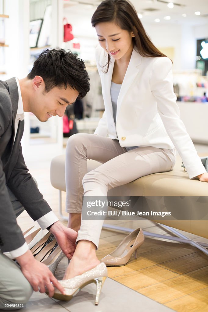 Young couple buying shoes in shop