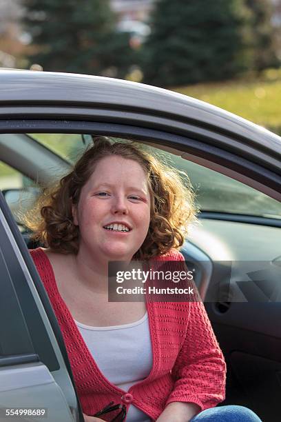 young woman with autism sitting in her car - hemangioma fotografías e imágenes de stock