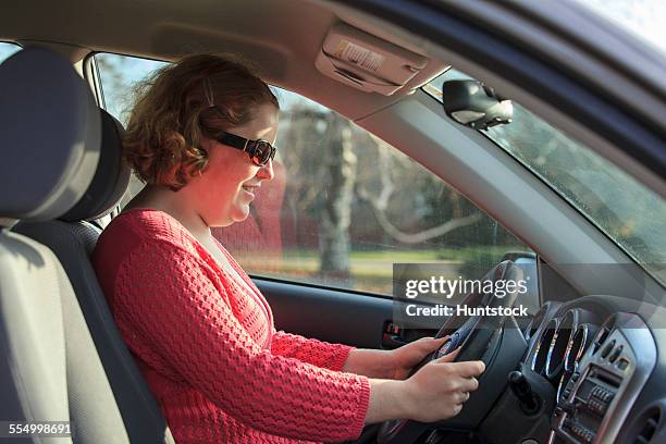 young woman with autism sitting in the drivers seat of her car - hemangioma fotografías e imágenes de stock