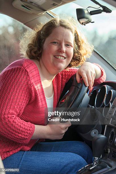 young woman with autism sitting in the drivers seat of her car - hemangioma fotografías e imágenes de stock