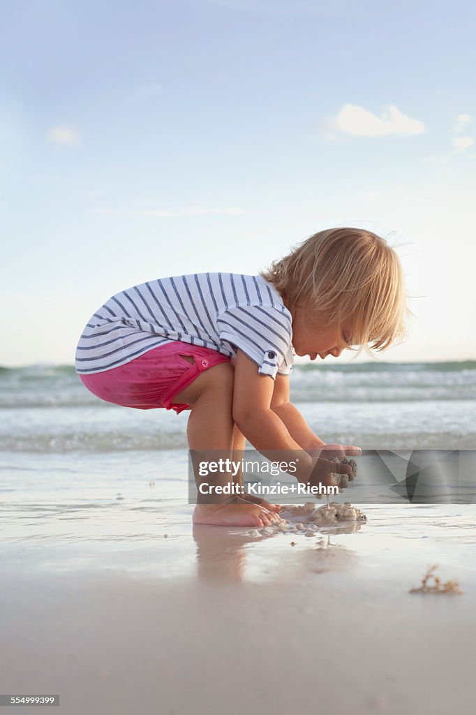 Boy exploring on the beach at sunset