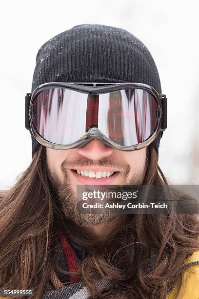 close up portrait of smiling male snowboarder on street - ski goggles stock pictures, royalty-free photos & images