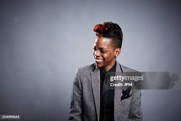 portrait of young woman, looking away, smiling - androgynous stock pictures, royalty-free photos & images